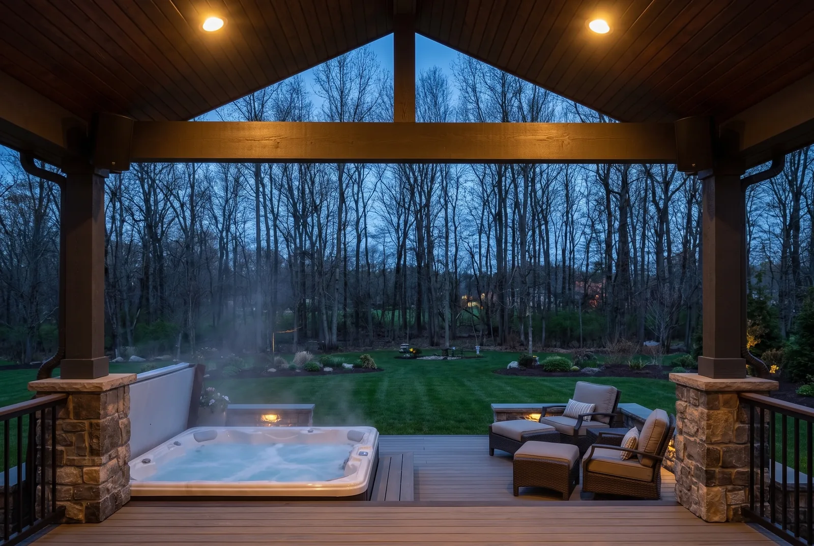 Covered backyard deck at dusk with outdoor speakers mounted under the roof